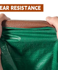 Hands holding green and brown 5x7 Ft Waterproof Tarp Built With 7 Mil Thick Poly, showing tear resistance and water droplets.
