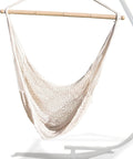 Chill Out Hammock Net Chair With Breathable Cotton Netting No Assembly Needed Conforms To Your Body For Maximum Comfort 220 LB Weight Capacity Indoor Outdoor Rope Lounge Seat hanging from a stand.