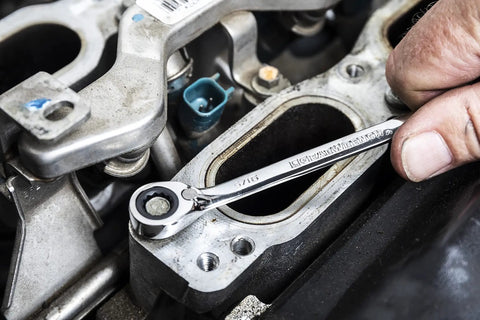 Mechanic using Beefy Thirteen Piece SAE Reversible Ratcheting Wrench Set with 12 Point Box Ends on engine part
