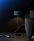 One Foot White 360 Degree Rotating Extension Cord With Flat Plug 3 Prong Grounded Indoor Power Cable used beside a couch and lamp.
