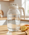 2 Quart Glass Pitcher With Filter Lid Airtight Leakproof 64 Oz Cold Water Jug on kitchen counter with lemon