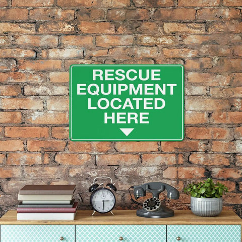 Green aluminum rescue equipment sign on brick wall above table with decor items