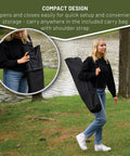 Woman carrying Portable Hammock Camping Chair With Stand in a black carry bag by a lake