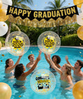Class Of 2026 Graduation Beach Balls Set 11 Inch Inflatable Party Balls With Glitter Gold And Black Markers For Senior Celebrations Poolside Beach Decor And Gift Favors 10 Pack in a pool with people.