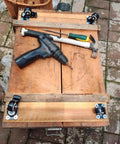 Set Of 4 Heavy Duty Swivel Caster Wheels With Secure Brakes attached to a wooden workbench with tools.