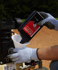 User pouring oil into the Honda engine of the 135 Psi 5.5 Hp Gas Powered Air Compressor for maintenance.