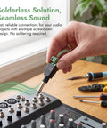 Hand connecting a Straight Up 1/4 Inch Jack Mono Male Plug to a stage mixer, showcasing solderless audio connection.