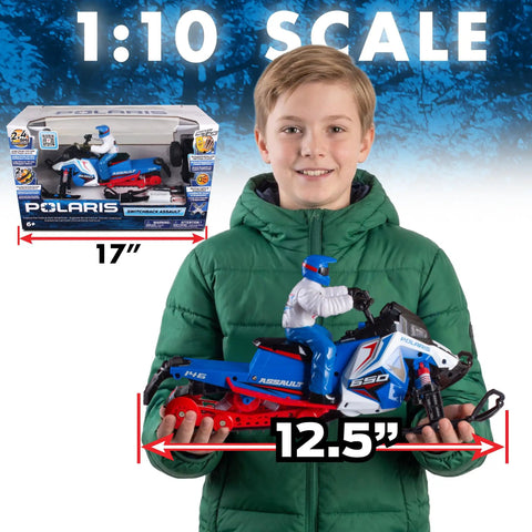 Child holding Switchback Assault RC Beast with Dual Ski System 2.4GHz RTR, showcasing scale with packaging in background.