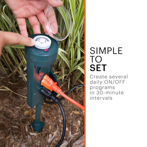 Rad 6 Outlet Outdoor Mechanical Stake Timer Featuring Kickass Heavy Duty Construction And Weather Resistant Covers in garden setting with cord and dial.