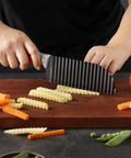 Crinkle cut knife with ribbed black blade and rubber handle for slicing veggies; dishwasher safe