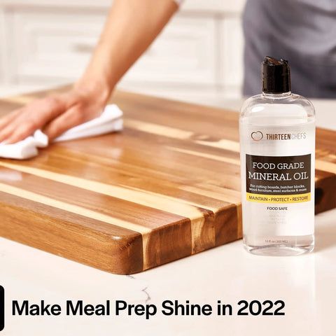Food Grade Mineral Oil For Wood Cutting Boards, Countertops And Butcher Blocks bottle beside wood surface being wiped