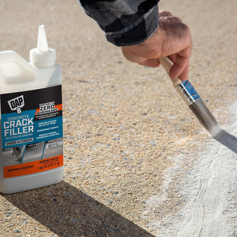 Concrete Crack Filler Gray 1.62 Lb Water Activated Dry Powder For Quick Fixes Of Horizontal Cracks In Concrete And Masonry Materials, Ready For Light Foot Traffic In About 4 Hours being applied to a crack in concrete.