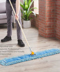 Top Shelf Loop End Cotton Dust Mop Head 48 Inches Wide For Rapid Hard Surface Cleaning In Blue being used on a floor.