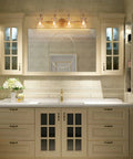 Gold Modern Bathroom Vanity Lights Over Mirror With Four Clear Glass Shades, Minimalist Luxury Design in master bath.