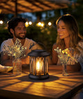 Evening scene with couple enjoying Hangin Solar Lanterns For Outdoors Waterproof 2 Pack Clip And Handle Patio Garden Lights Auto On Off