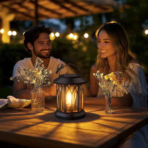 Evening scene with couple enjoying Hangin Solar Lanterns For Outdoors Waterproof 2 Pack Clip And Handle Patio Garden Lights Auto On Off