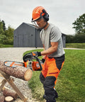 Person using a 12 Inch Top Handle Gas Chainsaw with 25.4cc 2 Stroke Engine for cutting firewood, ergonomic handle visible