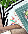 Assorted colorful poly mailers and thank you designs on a wooden table, showing variety in iMailer collection.