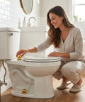 Woman installing Darn Slick Ceramic Gold Octopus Toilet Bolt Caps on toilet for decorative finish in bathroom.