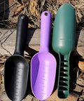 Three garden tools, including a black thickened plastic garden soil scoop with ergonomic handle, on wooden surface