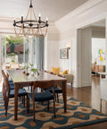 Natural Boho 28 Inch Chandelier With Wooden Bead Tassels And Rust Iron Black Wagon Wheel Frame, 6 Light Ceiling Lighting in dining room