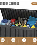 90 Gallon Outdoor Deck Box With Wheels Lockable Waterproof Weatherproof Resin Storage Chest for Patio Furniture Cushions Pool Floats Garden Tools Backyard Gear, Black, filled with various outdoor items.