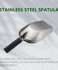 A stainless steel spatula with black handle displayed on a textured surface with shadow.