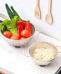 Stainless Steel Colander 3 Quart Strainer For Kitchen Food Prep Dishwasher Safe with vegetables and pasta on countertop