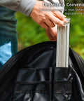 Person placing metal part into Medium Heat Deflector Carry Bag For Bonfire Accessories Weather Resistant Protective Gear Case With Durable Zipper And Handles 600D Solution Dyed Material With PVC Backing Fits 25.8 Inch Deflector