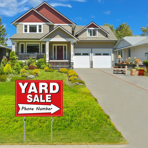 Yard sale sign on lawn, red sign with white 'YARD SALE' text and arrow, mounted on two metal stakes.