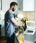 Big Capacity Clear Ice Maker For Home Bar 40 Lbs Output Stainless Steel on countertop beside couple in kitchen