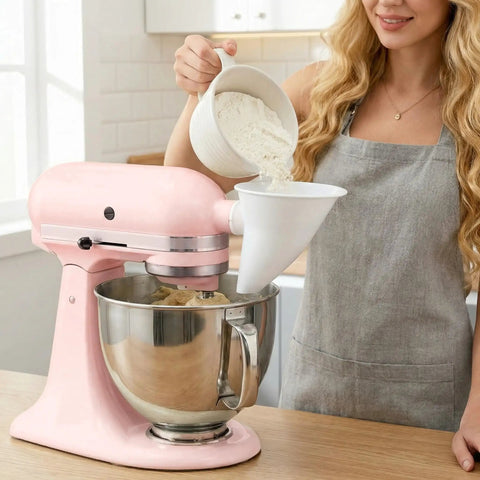 Person using Mess-Free Flour Funnel Attachment for Stand Mixers with Extended Splash Guard while adding flour to tilt-head bowl.