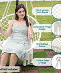 Woman sitting in Macrame Hammock Chair Hanging Swing For Indoor Outdoor Use 330 Lbs Capacity Handwoven Cotton Rope Includes 2 Cushions And Hardware Kit Beige, steel frame visible