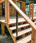 Wooden deck railing with One Eighth Inch Stainless Steel Wire Rope Kit 400 Feet Of Aircraft Cable and M5 Turnbuckles installed