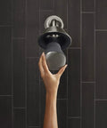 Hand touching 2.5 GPM Showerhead With Bluetooth Speaker And Harman Kardon Audio, Waterproof Shower Upgrade For Home, Seamless Pairing, Clear Bass, Vibrant Finish For Any Bathroom Setup