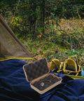 Rugged Wear Resistant Shockproof Tool Case For Outdoor Survival And Gear Storage open on camping gear in forest setting