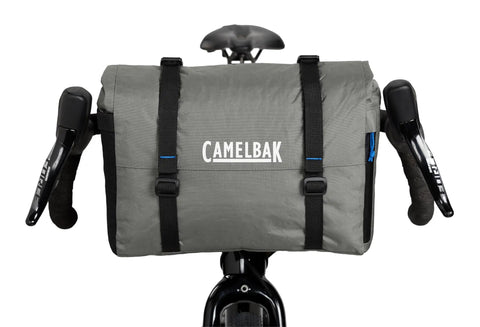 Front view of MULE 12 Bikepacking Handlebar Bag IPX5 Waterproof Roll-Top with Aluminum Stabilizer Bar in Wolf Grey 2.0 on bike