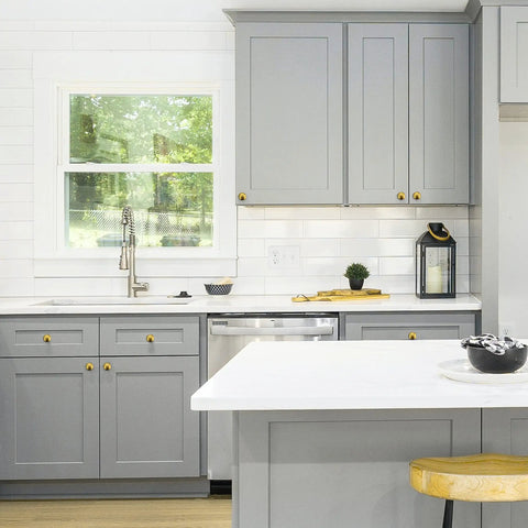 Premium Zinc Cabinet Knobs Featuring A Killer Gold Finish And Fresh Euro Style Vibe Built Different For Long Lasting Performance A Straight Up Quality 30 Pack Furniture Hardware Refresh installed on gray kitchen cabinets.