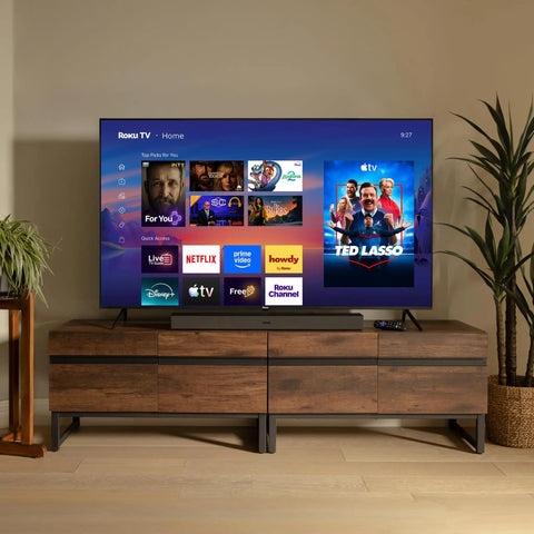 55 Inch QLED Smart TV With Sharp 4K Resolution And Rich HDR10 Colors Plus Slick Built In Apps For Smooth Streaming displayed in a modern living room.