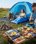 Grab And Go All In One 11 Piece Camping Gear Set For One To Two People Including Tent Sleeping Bag Stainless Steel Mess Kit Waterproof Tarp And More For Backpacking Road Trips Beach Backyard Fun And Family Campouts scene with tent, tarp, and table with food