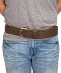 Person wearing 2 Inch Wide Full Grain Leather Tool Belt For Pros 100 Percent Cowhide With Double Tongue Steel Roller Buckle Heavy Duty Belt