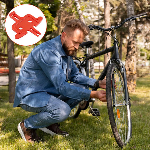 Man adjusting wheel near MTB bike with 4 Piece Bicycle Brake Spacer Set For Disc Brakes And Hydraulic Systems shown in insert.