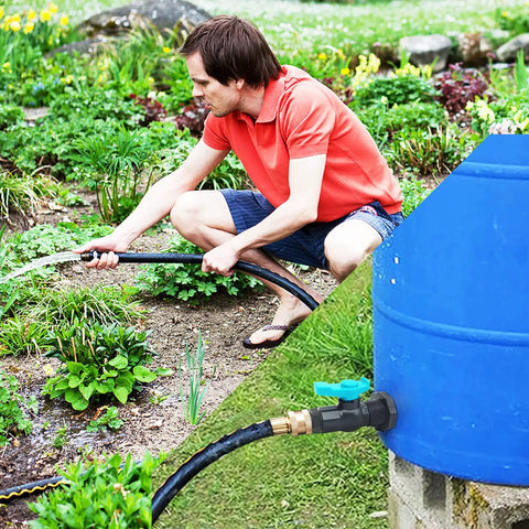 Man using Rain Barrel Spigot Kit With Hole Saw, PVC Bulkhead Fitting, Ball Valve, Thread Seal Tape, And Garden Hose in garden