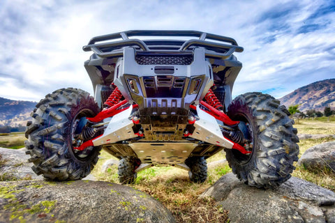 20 Piece UTV Skid Plate Bolts and Washers Kit for Polaris installed on vehicle in rocky terrain, showing underside protection.