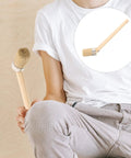 Person holding Round Head Paint Brush For Walls And Wood Stain, 50mm Natural Bristle With Wood Handle for DIY projects