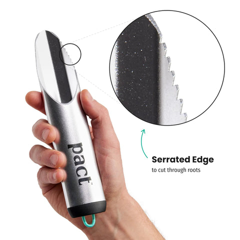 Hand holding award winning ultra lightweight aluminum backpacking shovel for camping and hiking ergonomic trowel, focus on serrated edge.