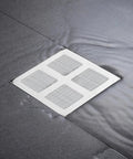 Lcarege Disposable Hair Drain Stickers, 60 Pack 4x4 Fiberglass Disposable Drain Covers on a wet shower floor.