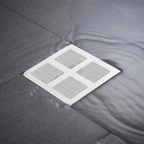 Lcarege Disposable Hair Drain Stickers, 60 Pack 4x4 Fiberglass Disposable Drain Covers on a wet shower floor.