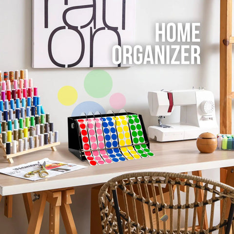 Rock Solid Acrylic Label Dispenser With Grippy Non Slip Base keeps sticker rolls tidy in a colorful home workspace.