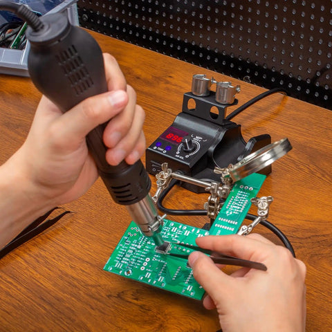 Compact Hot Air Rework Station Kit With Integrated Nozzle Holder in use for precise PCB soldering with tweezers